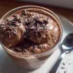 Bowl of creamy chocolate chia seed pudding with a spoon