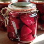 Jars of delicious pickled beets on a wooden table