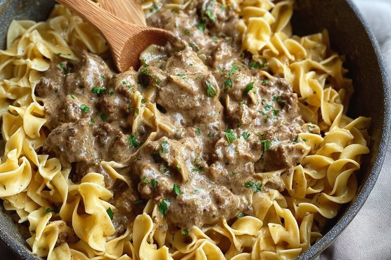 Delicious ground beef stroganoff served with noodles and garnished with parsley
