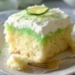 Delicious Lemon Lime Jello Poke Cake topped with whipped cream and citrus slices