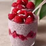 Delicious homemade raspberry chia pudding with fresh berries and nuts